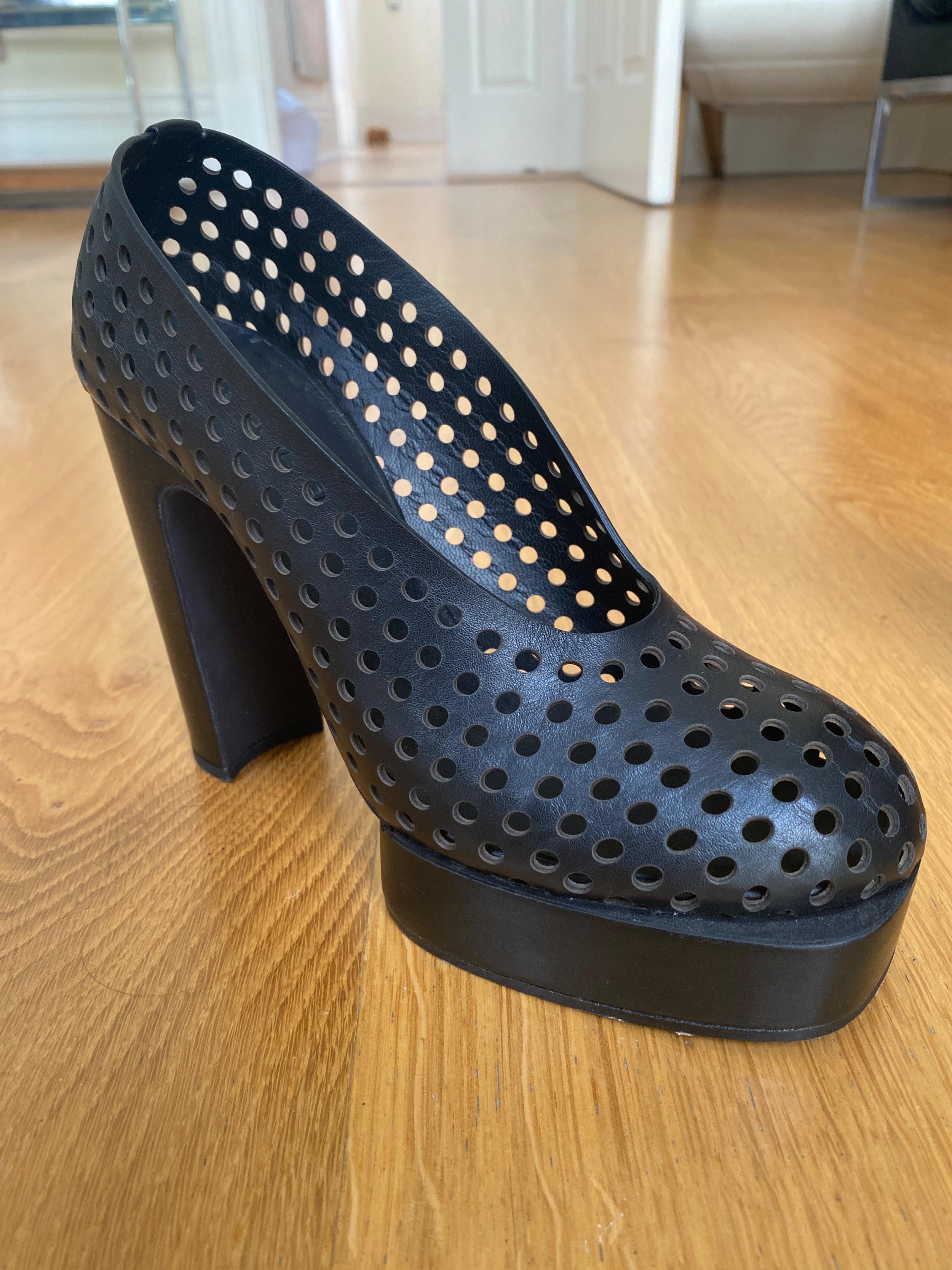 Black perforated leather platform heeled pumps