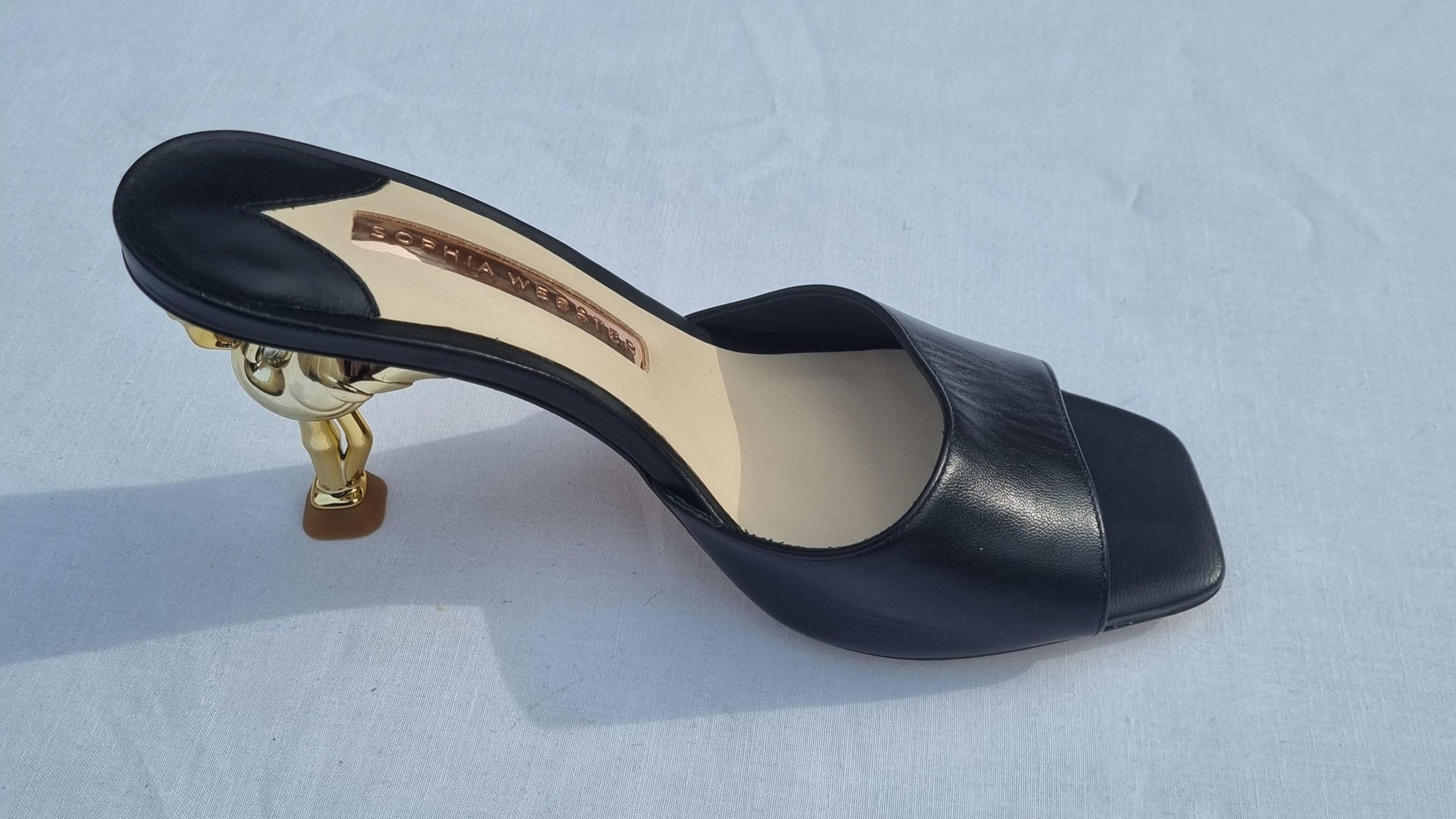 Black leather gold-tone flamingo Flo heeled mules