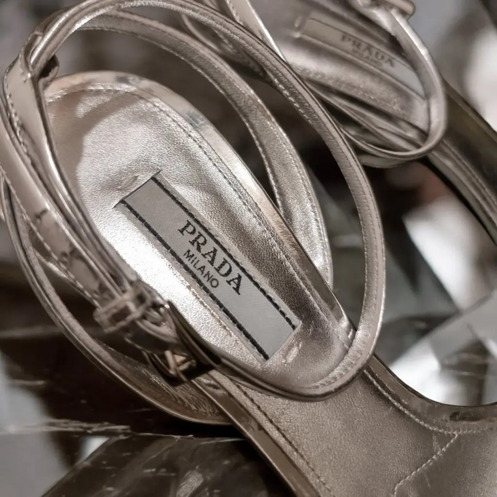 Prada Modellerie Logo-Plaque Metallic-Leather Sandals.