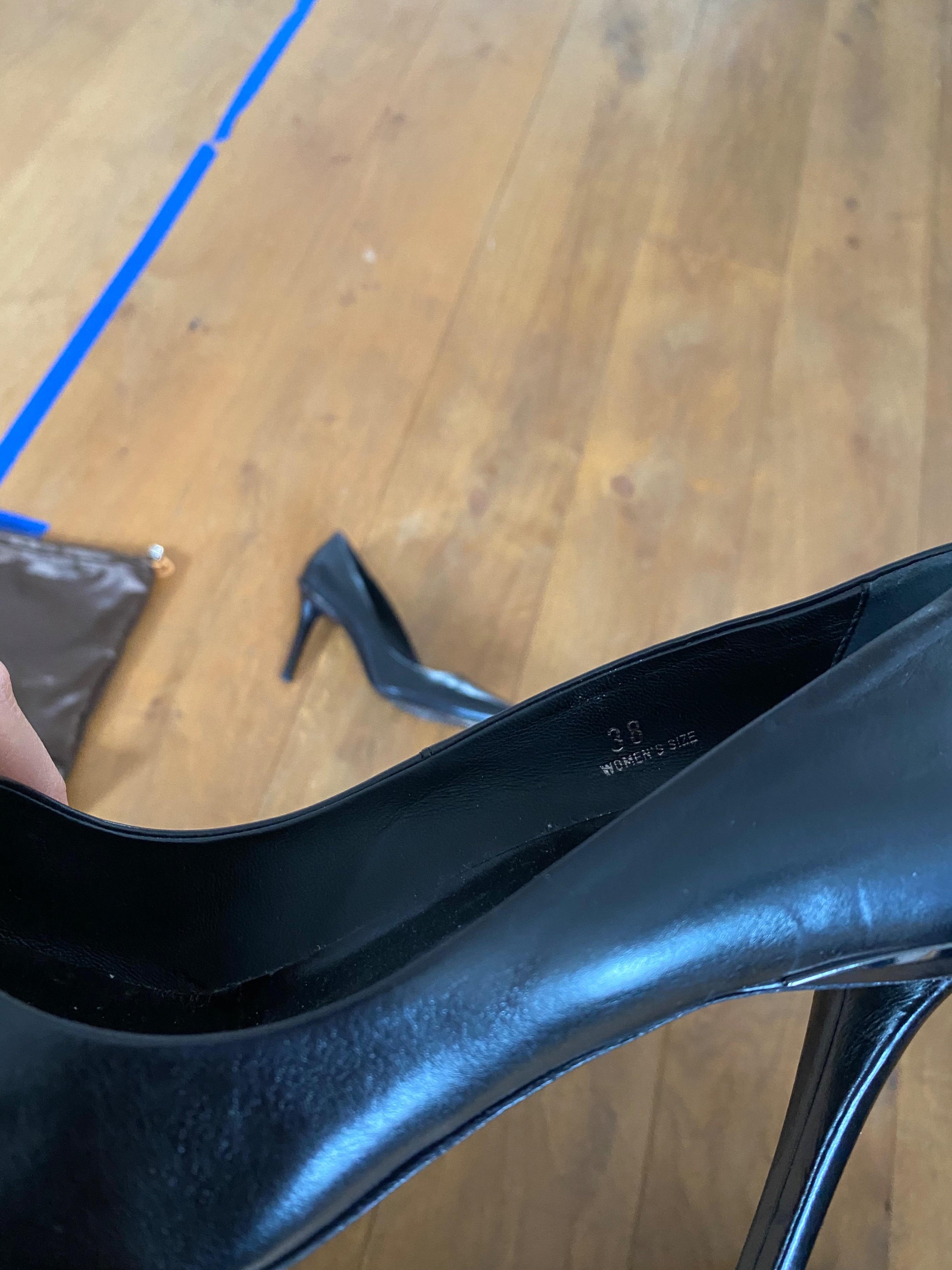 Black leather point toe heeled pumps