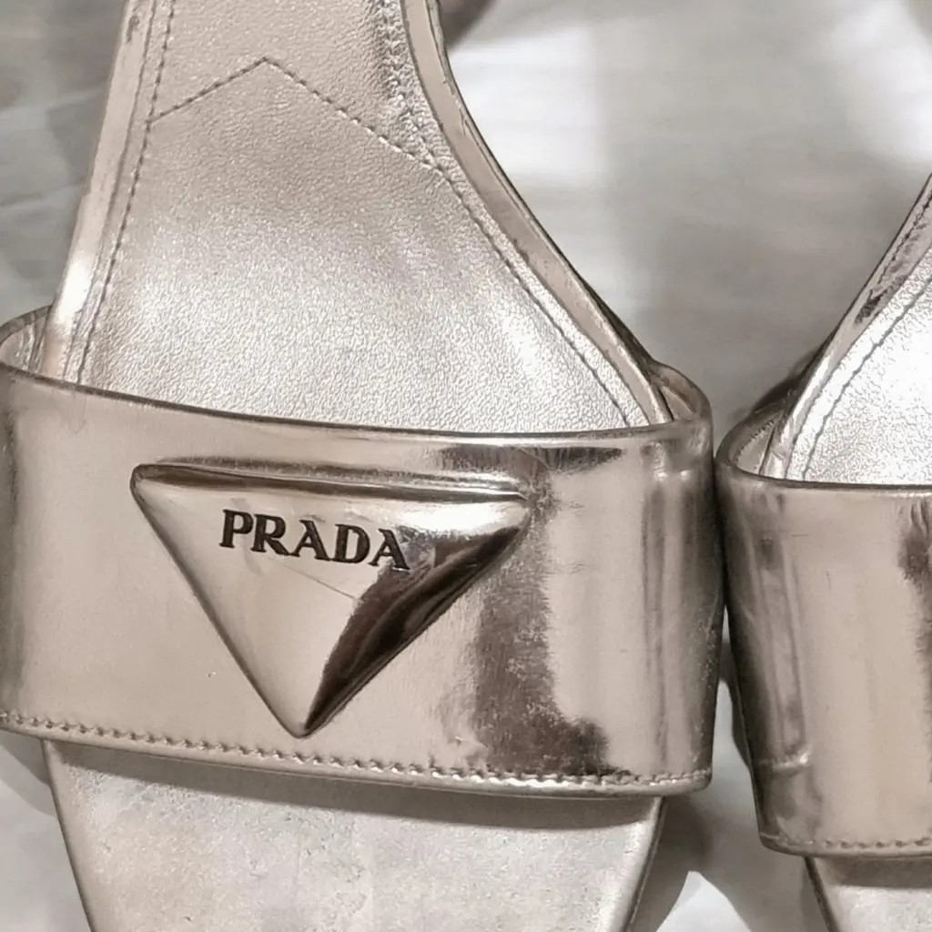 Prada Modellerie Logo-Plaque Metallic-Leather Sandals.