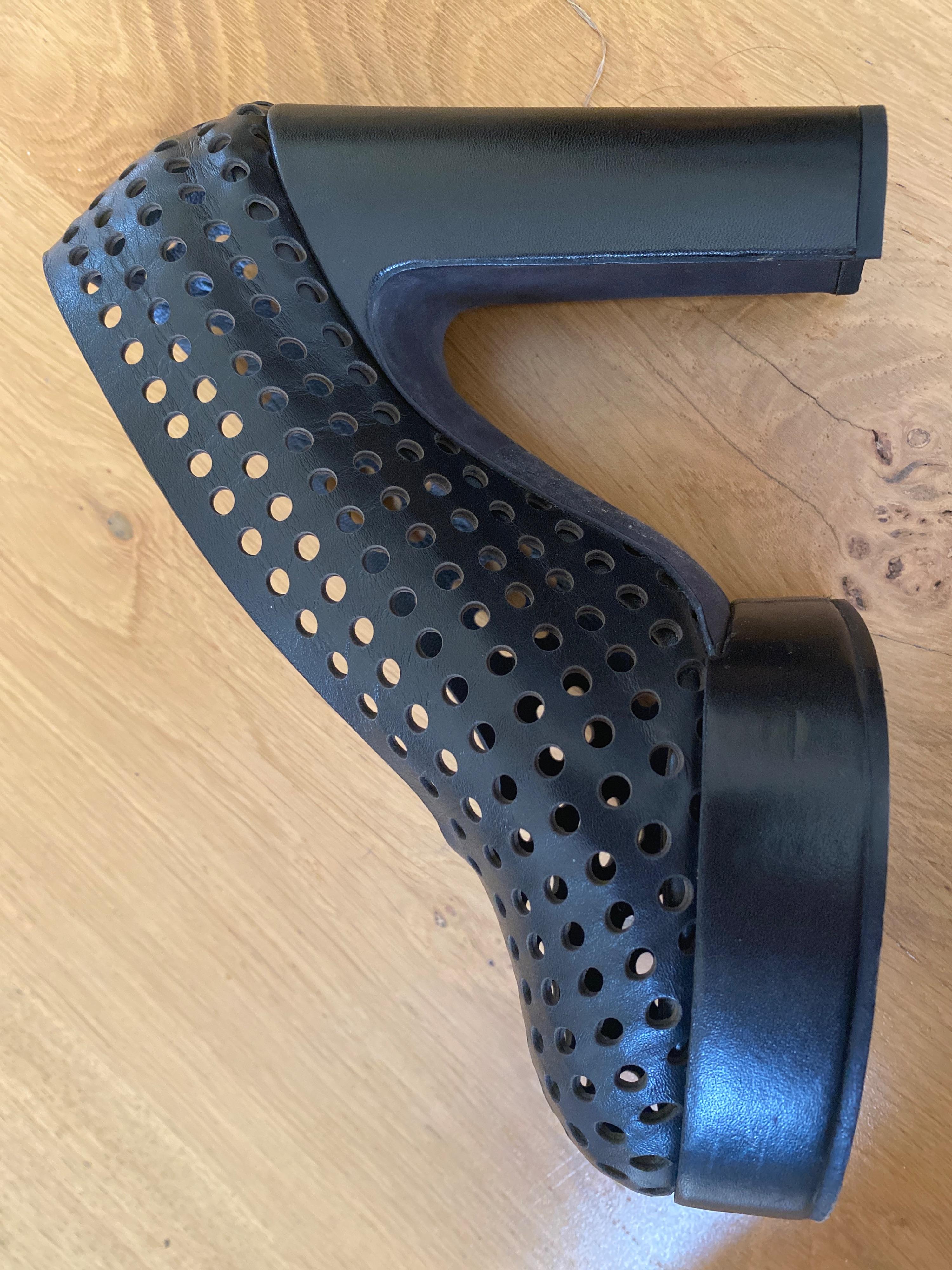 Black perforated leather platform heeled pumps