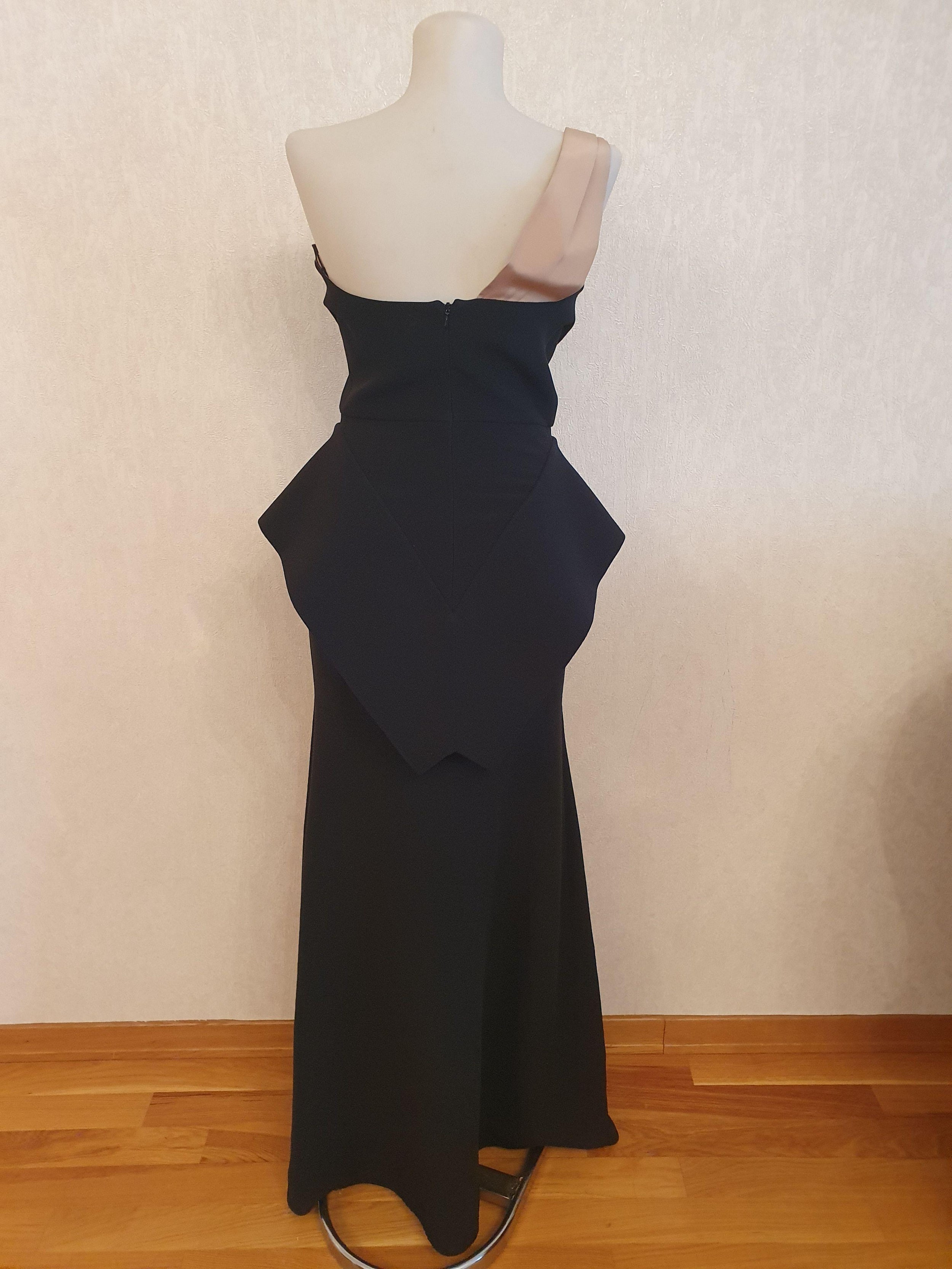 Black wool crepe one shoulder peplum gown