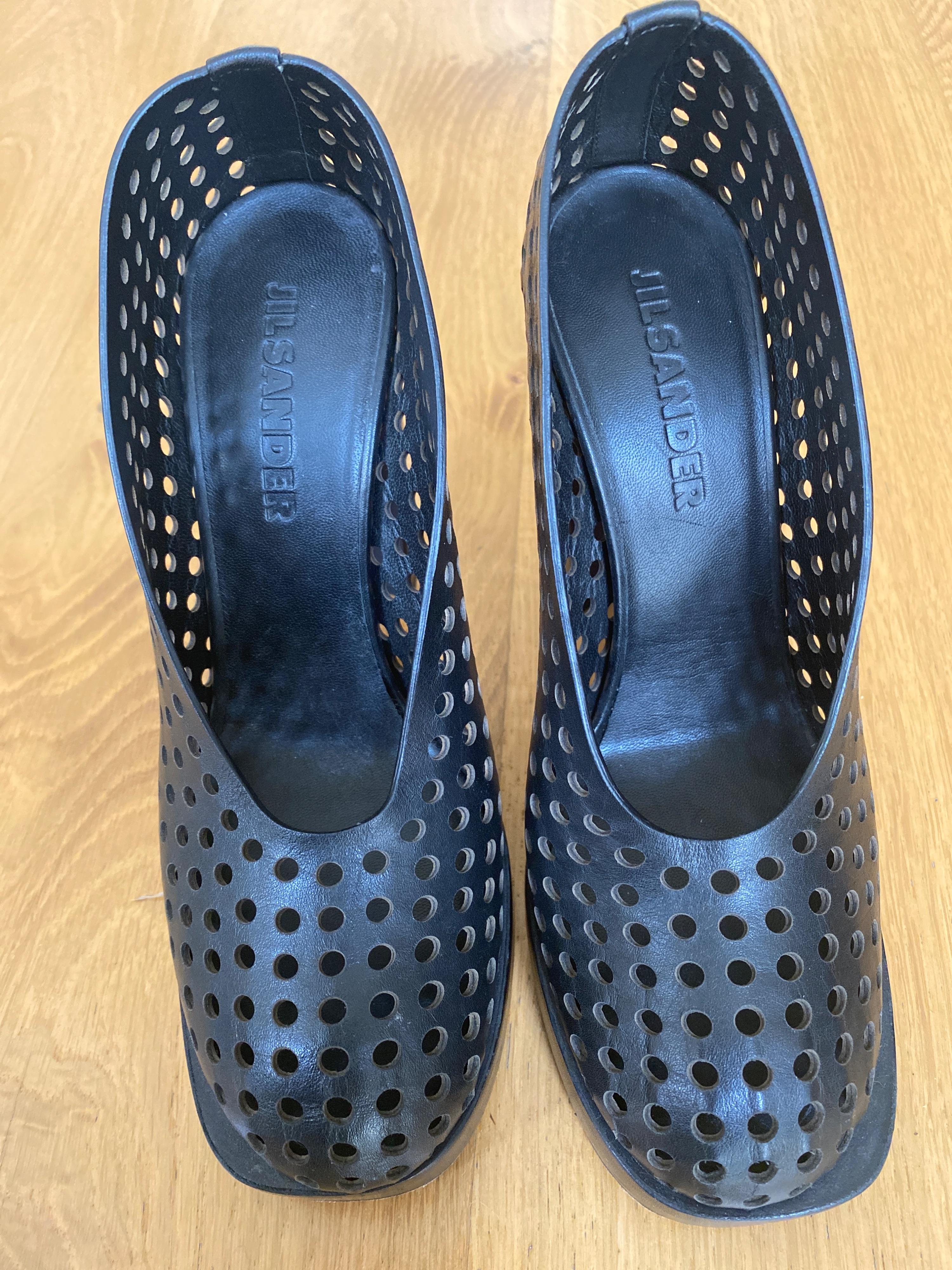 Black perforated leather platform heeled pumps