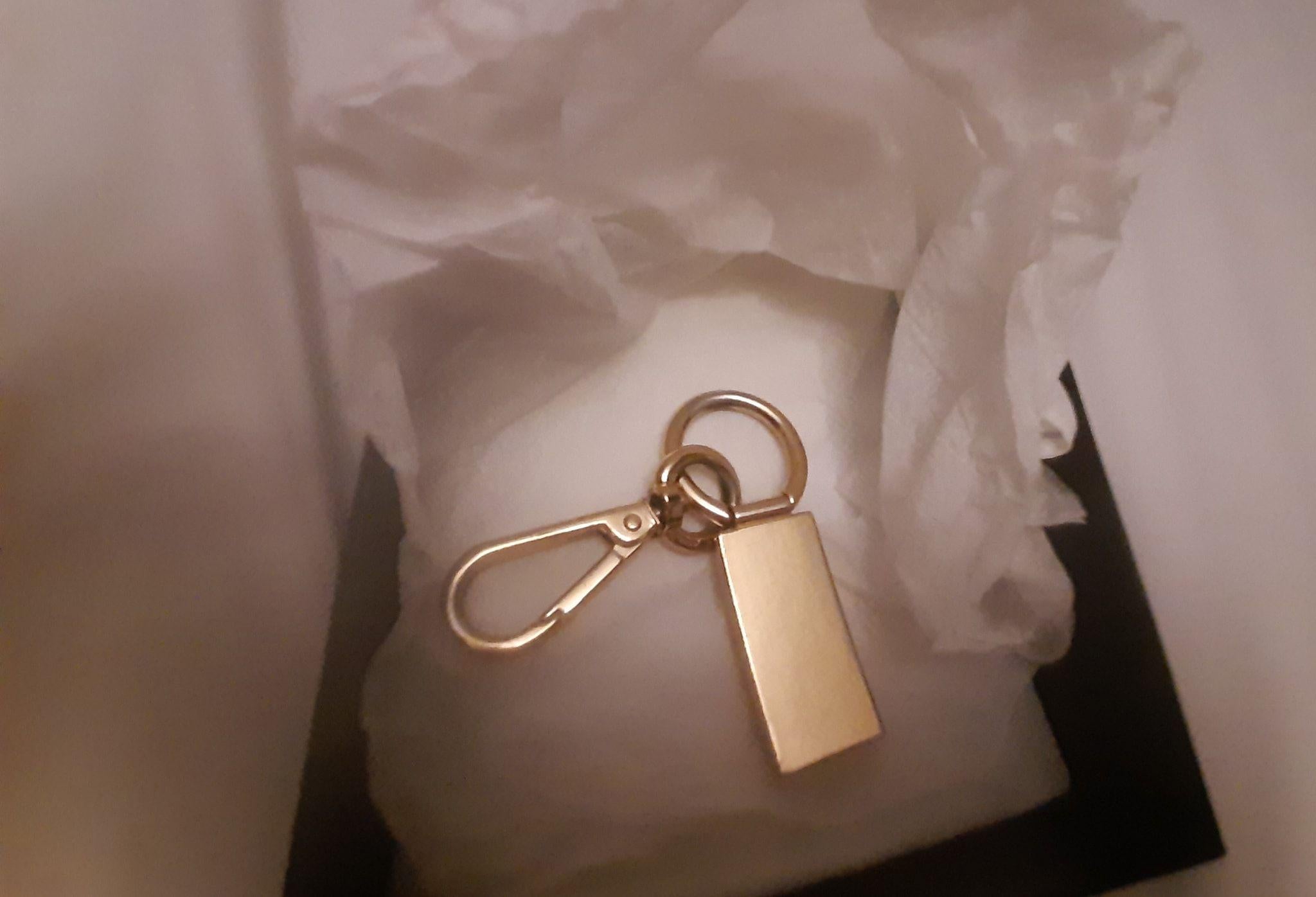 Gold-tone metal logo charm keyring
